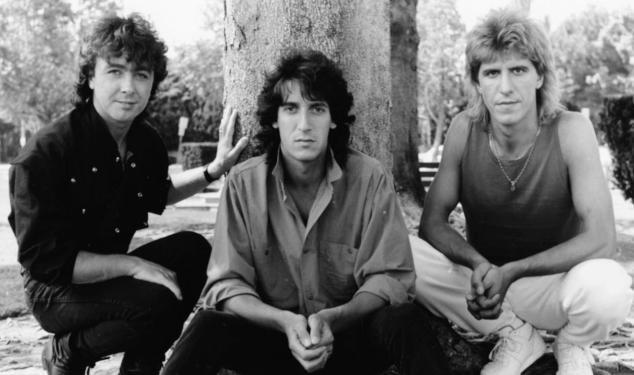 The Outfield Portrait of band 'The Outfield' on stage; (L-R) Tony Lewis, Alan Shadrake and John Spinks, May 28th 1986. 