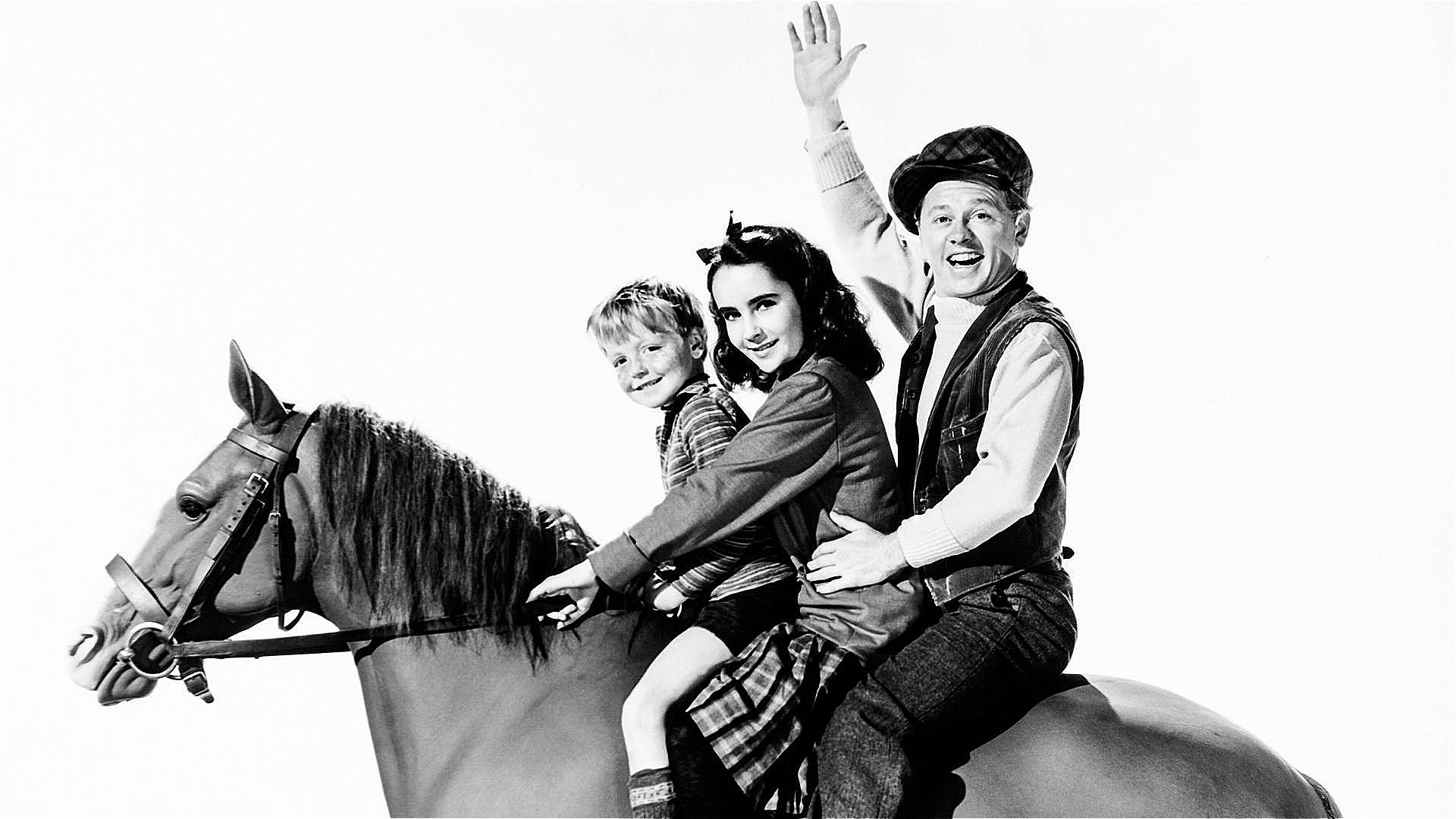 Promo still for the 1944 film National Velvet. Left to right, sitting on a model of a horse: Jackie