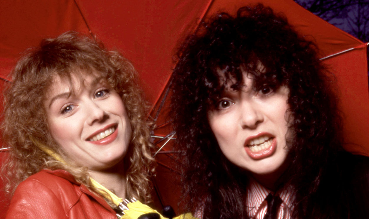 American musicians Nancy Wilson and Ann Wilson, of the American rock band Heart, pose for a portrait under an umbrella in Los Angeles, California, March 1980.