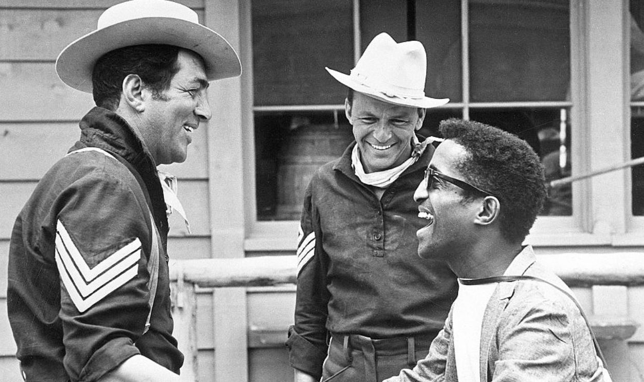 Sammy Davis Jr., Frank Sinatra and Dean Martin (Original Caption) 12/7/1961-Kanab, Utah: Sammy Davis Jr., Frank Sinatra and Dean Martin (LtoR) kill some time between takes of 