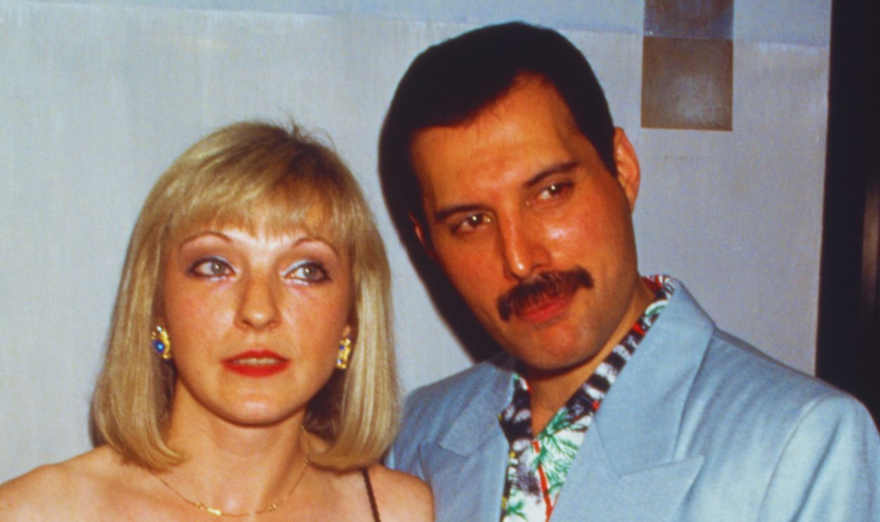 Freddie Mercury And Mary Austin Singer Freddie Mercury (1946 - 1991) with his friend Mary Austin at an after-party for Queen's Wembley concerts, Kensington Roof Gardens, London, 12th July 1986.