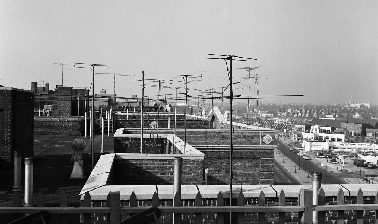 TV antennas on rooftops UNITED STATES - CIRCA 1950s: Television antennas on rooftops of buildings.