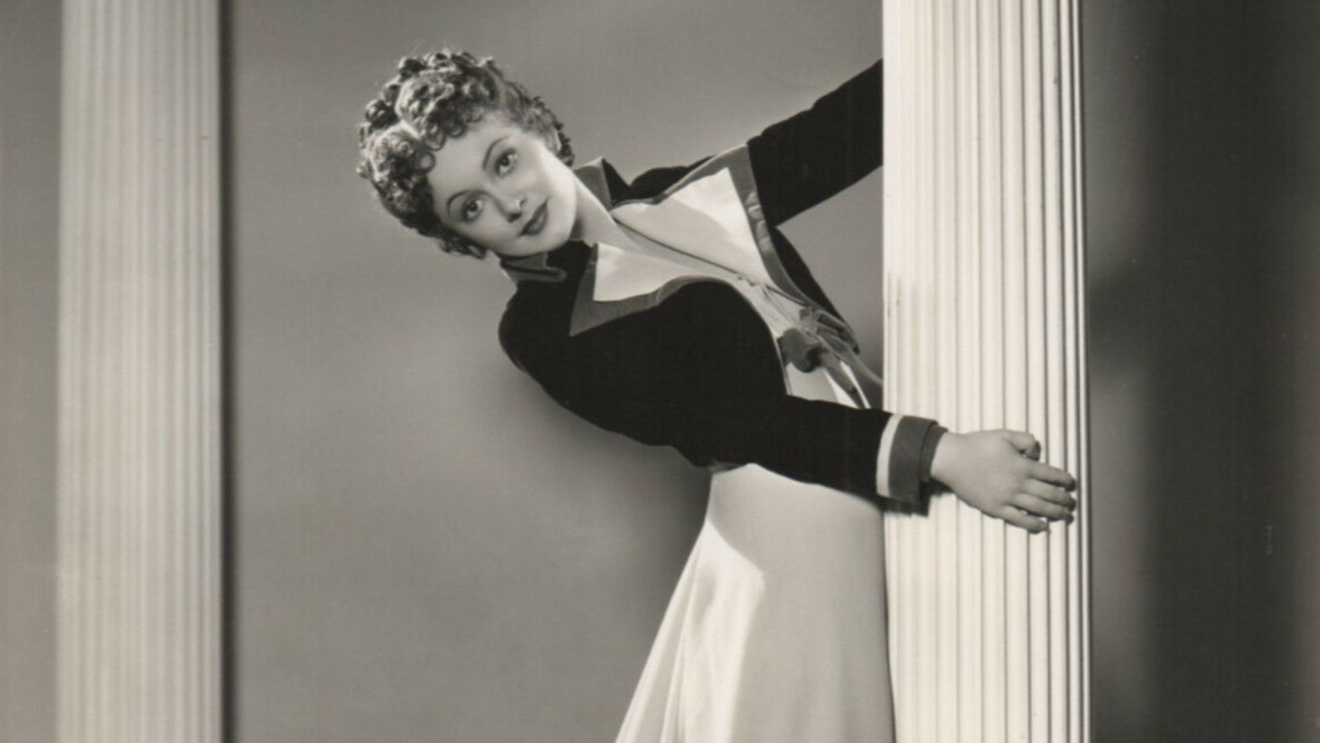 Olivia de Havilland. Publicity photo by Scotty Welbourne. On verso photographer's ink stamp