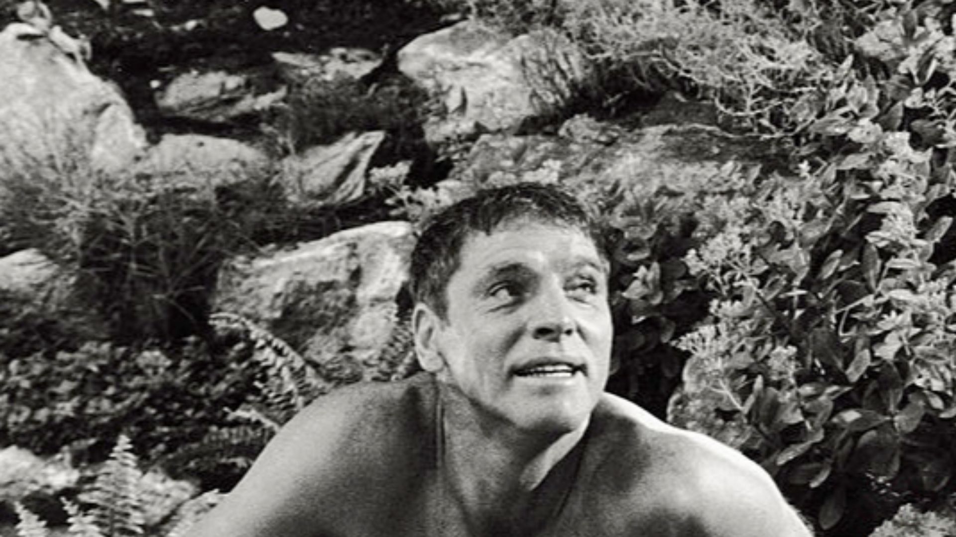 Actors Burt Lancaster and Janet Langard in a scene from the movie The Swimmer (1968); Lancaster, as Ned Merrill, is crouched at Janet Landgard (Julie Ann Hooper) feet. USA, 1968.