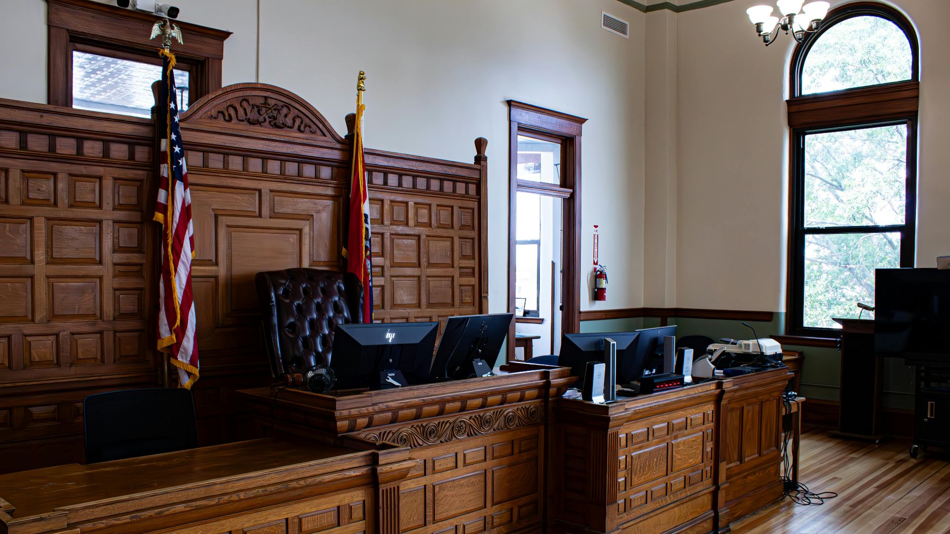 Interior view of an American courthouse in Kirksville, Missouri, featuring a judge's desk and flags.
