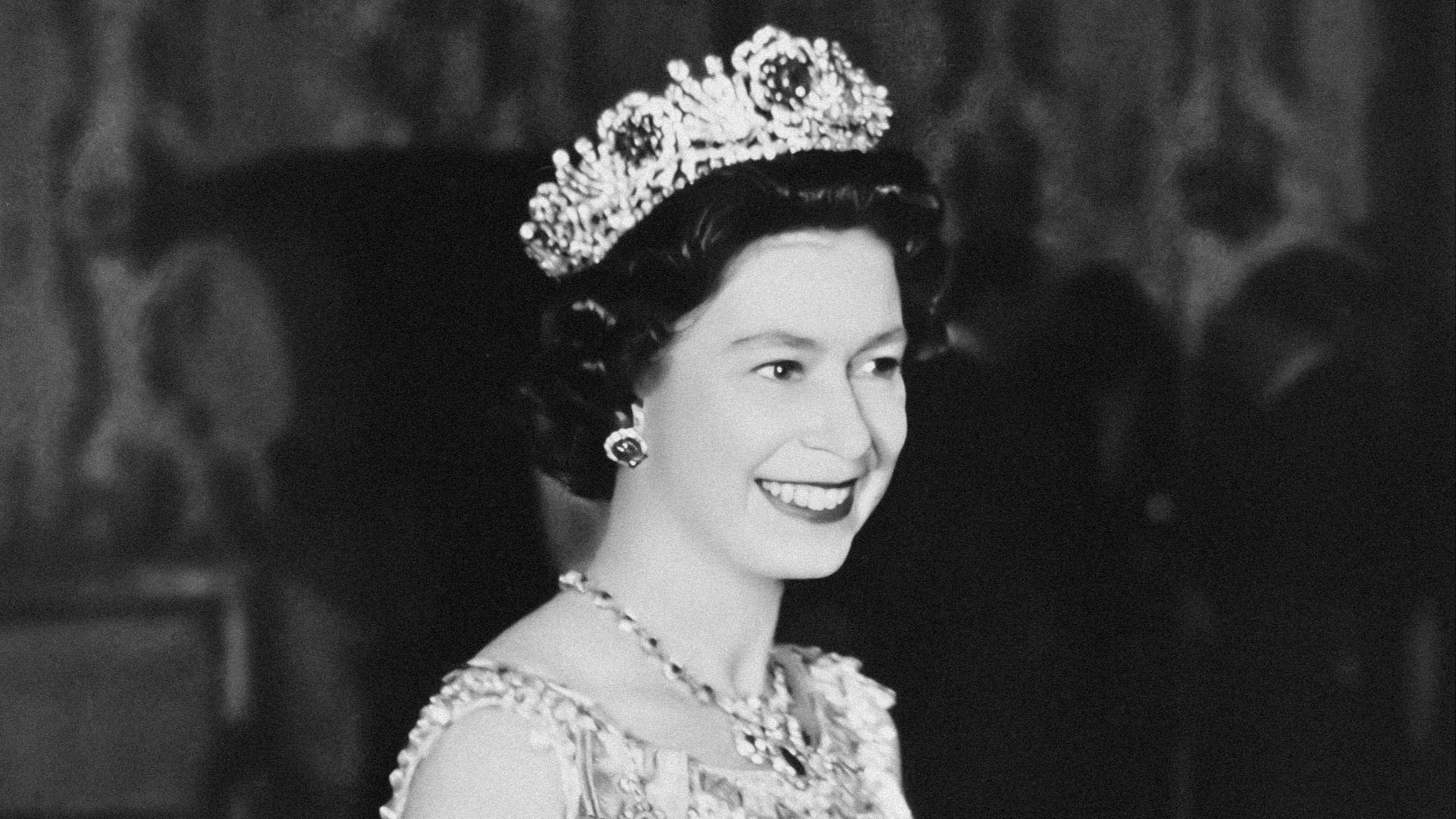 a black and white photo of a woman wearing a tiara