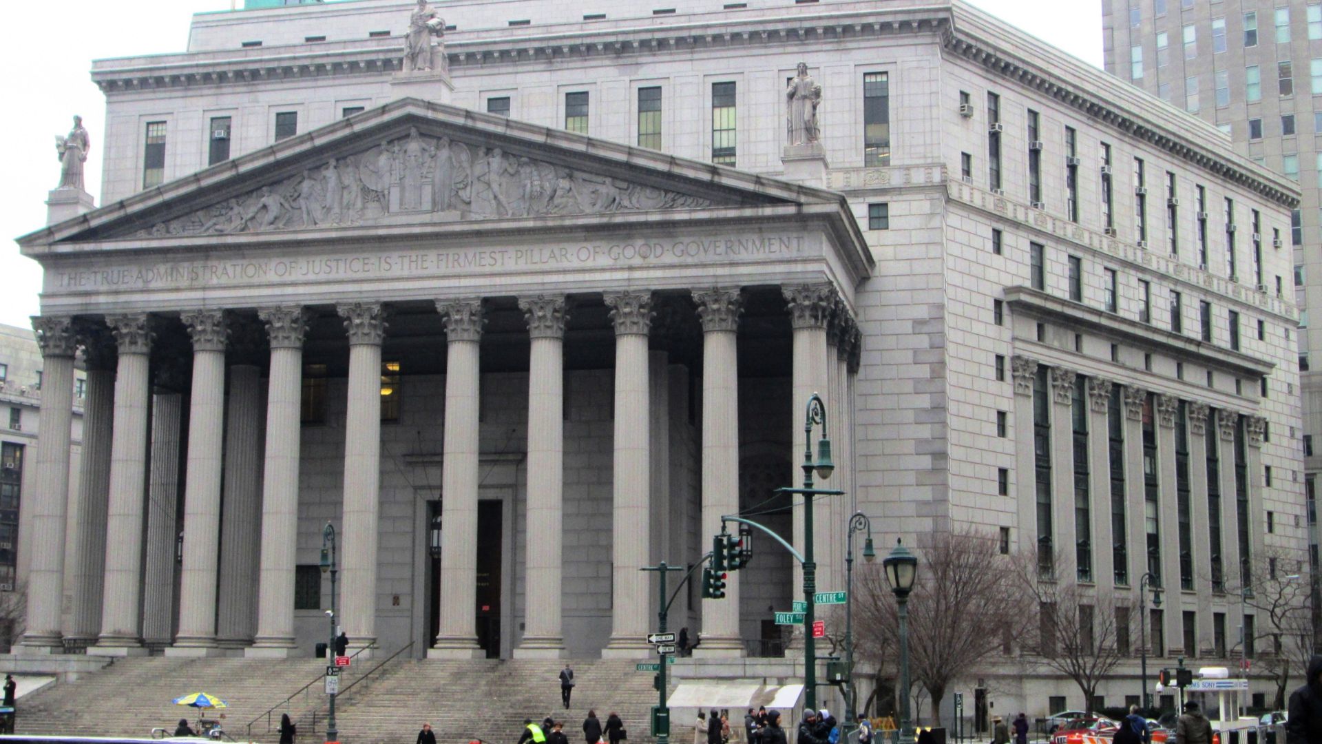 The New York State Supreme Court courthouse at 60 Centre Street on Foley Square in the Civic Center district of Manhattan, New York City was built 1913-27 as the New York County Courthouse, completion having been delayed by World War I, and was designed by Guy Lowell in the Classical Revival style.  It features a Corinthian portico and WPA-sponsored paintings by Attilio Pusterla inside from the 1930s.  Not obvioous from the outside, a plan viewe of the building shows that it is laid out in a hexagon with an interior courtyard. Both the interior and exterior are NYC landmarks. (Sources: AIA Guide to NYC (5th ed.) and Guide to NYC Landmarks (4th ed.))