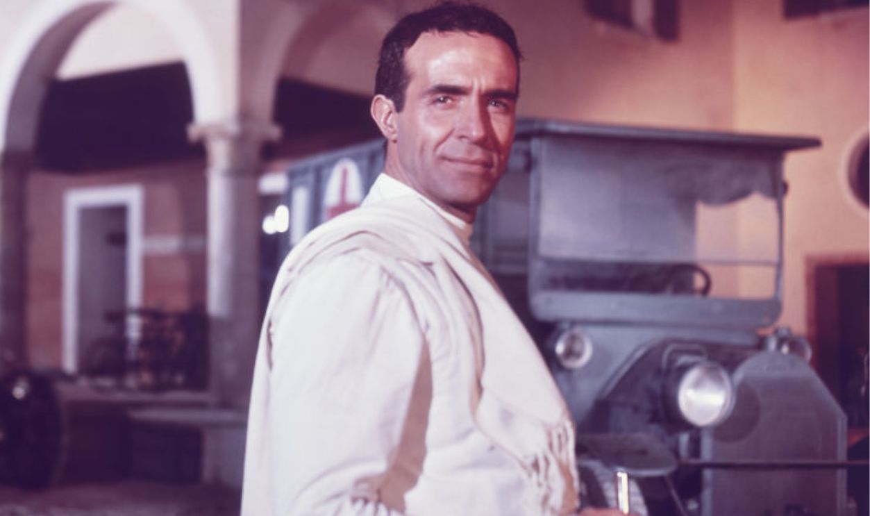 UNITED STATES - CIRCA 1965: Portrait of the actor Ricardo Montalban (1920 - 2009) from an unidentified movie, ca.1960s. He is holding a fencing sword and smiles while standing on the street.