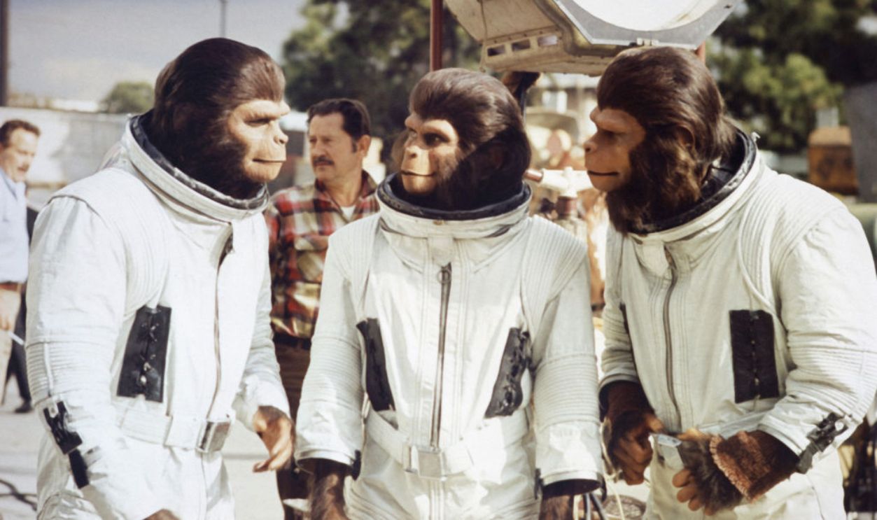Escape from Planet of the Apes Kim Hunter, Sal Mineo and Roddy McDowall in astronaut costume and ape make up discuss scene on the set of the classic 1971 movie.