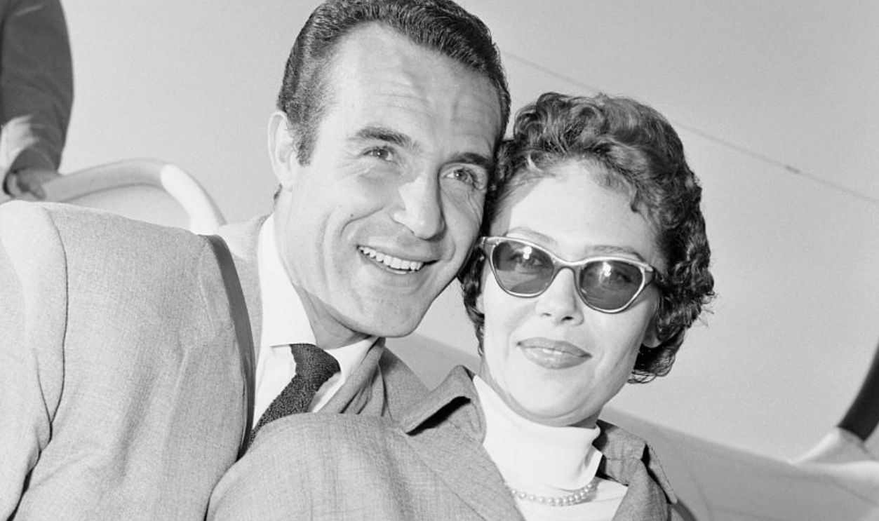 (Original Caption) Actor Ricardo Montalban gives his wife, Georgiana, a hug for the benefit of photographers at Rome's airport on thier arrival from Hollywood. Montalban is on Italy to star with Rhonda Fleming in the Courtesan of Babylon. His wife is a sister of actress loretta Young.