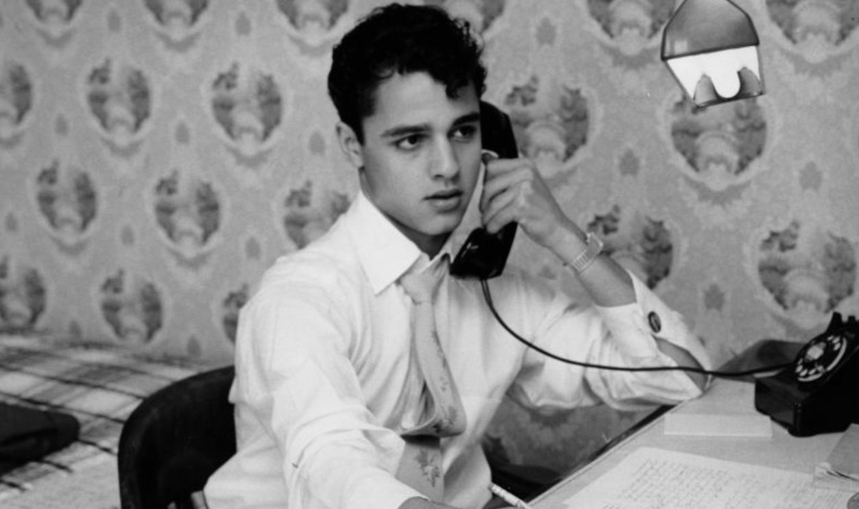 American actor Sal Mineo (1939 - 1976) writing at his desk, 1956.