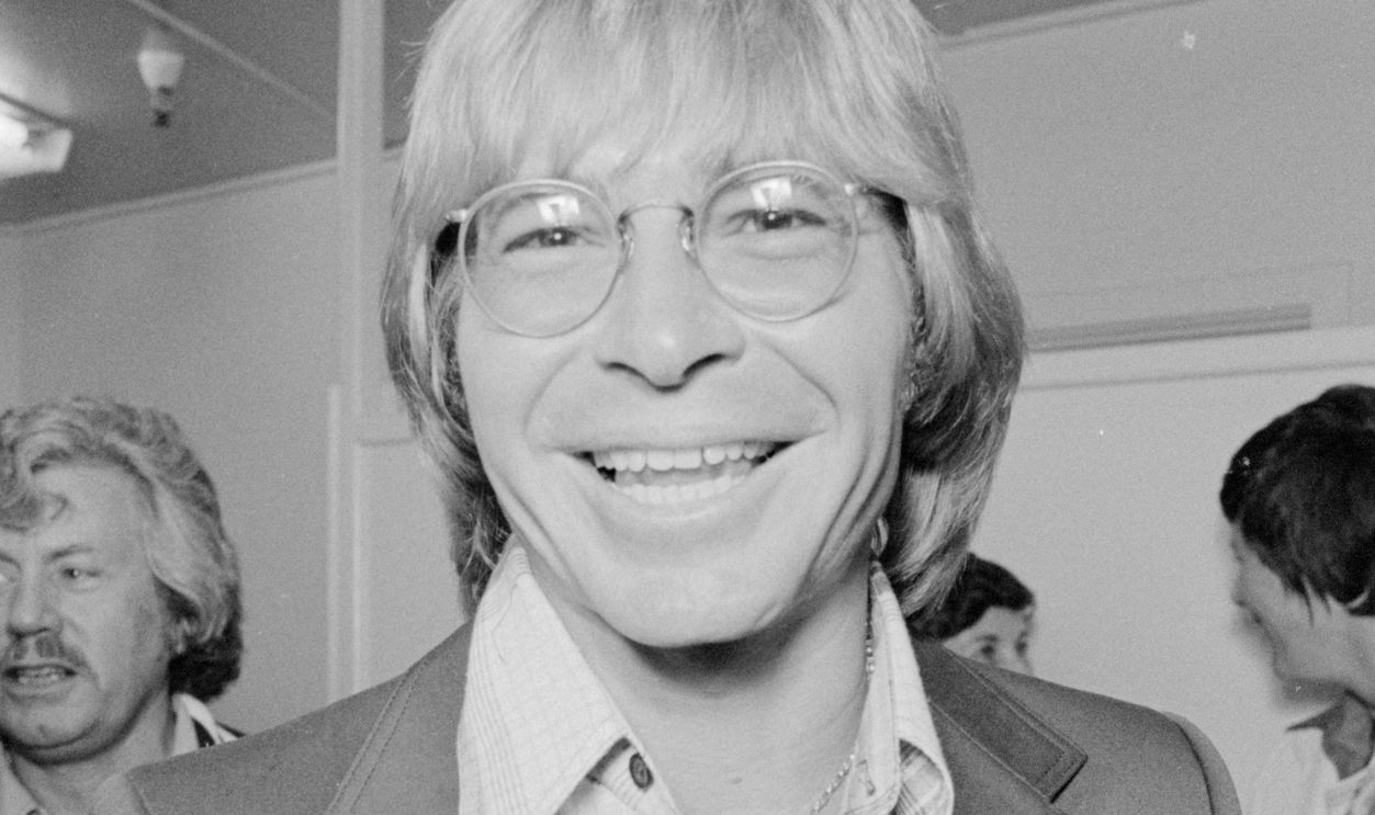 John Denver with Fans Backstage Singer John Denver gives a thumbs up and hangs out with a group of his fans backstage.