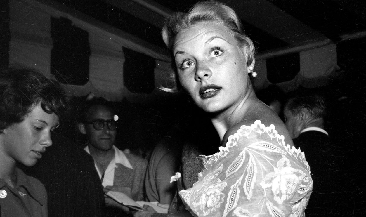 Actress Barbara Payton signs autographs for fans outside Mocambo's in Los Angeles,CA.