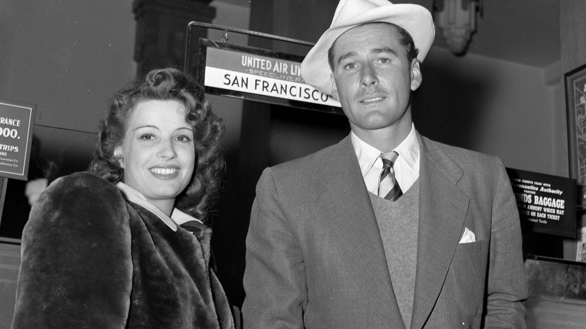 Title:  Actor Errol Flynn and wife Lili Damita at Los Angeles' Union Airport, as he returned from Honolulu trip.