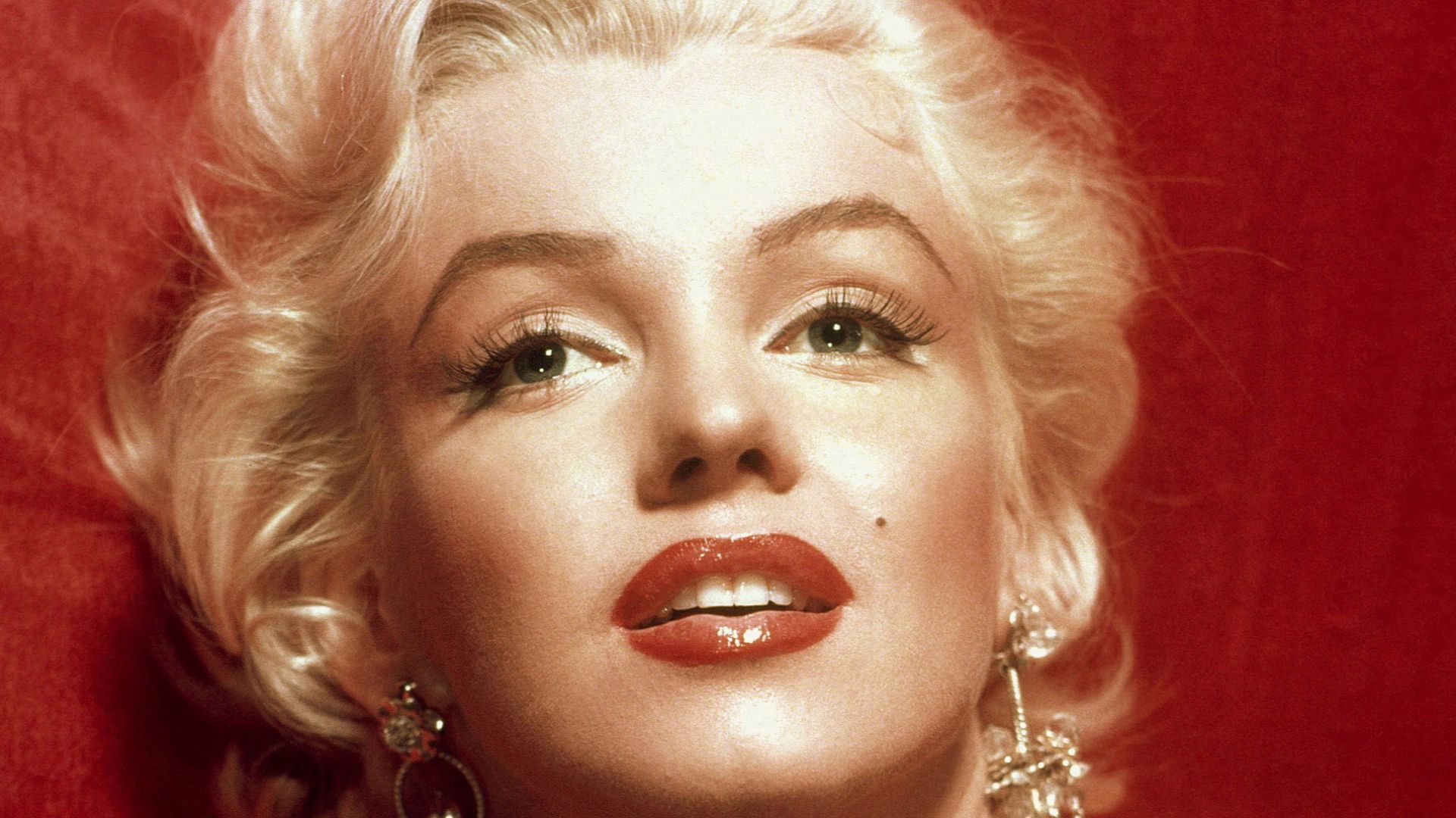 A glamorous Marilyn Monroe in a red dress, taken for publicity purposes for 1953 film How to Marry a Millionaire.