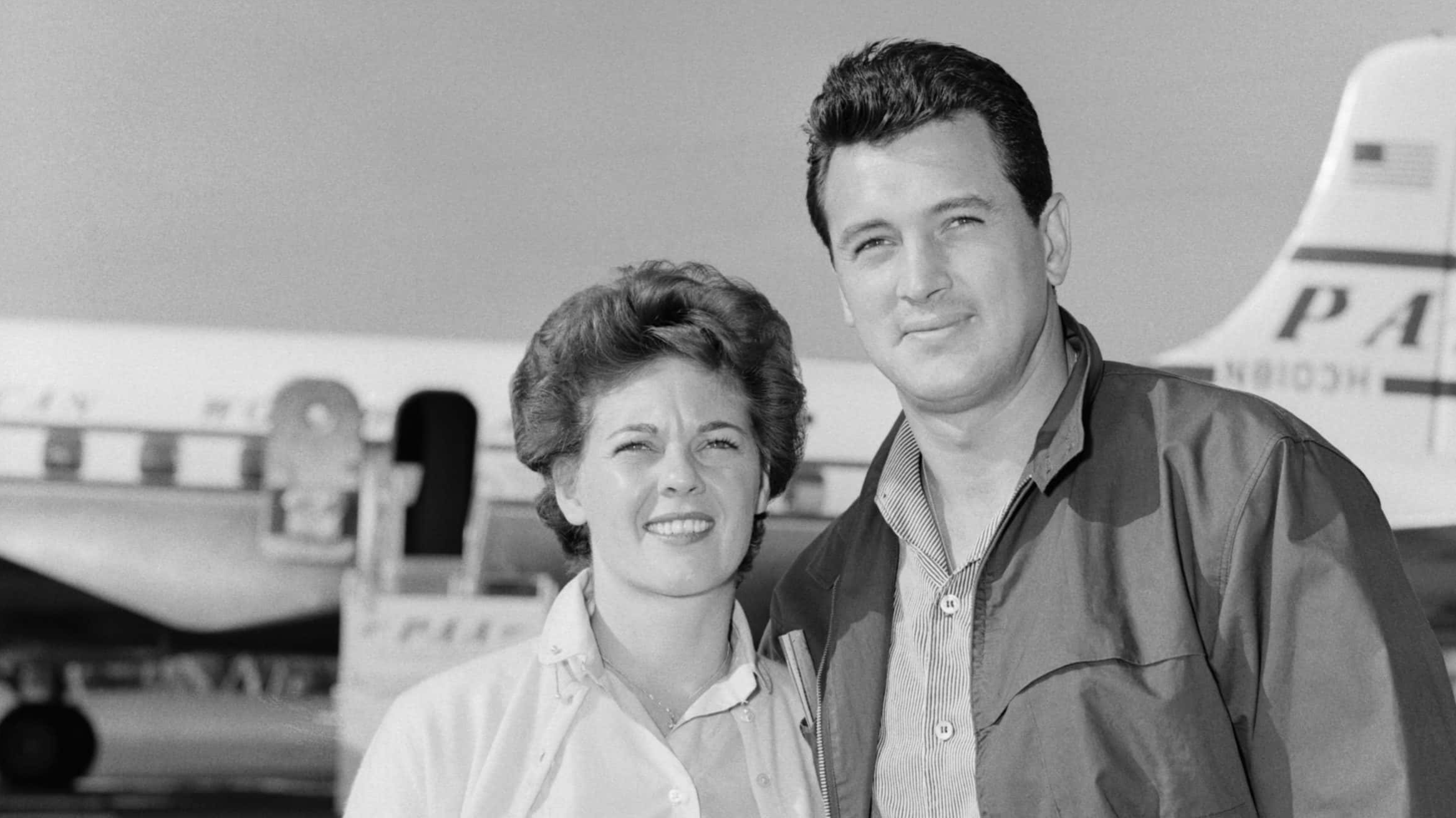 Rock Hudson With His Bride, Phyllis (Original Caption) 11/24/55-Miami, Florida: Movie star Rock Hudson with his bride of three days, former Phyllis Gates, 25, his agent's secretary, prepares to board a Pan American Clipper in Miami, Nov. 11, on the way to a honeymoon in Montego Bay, Jamaica.