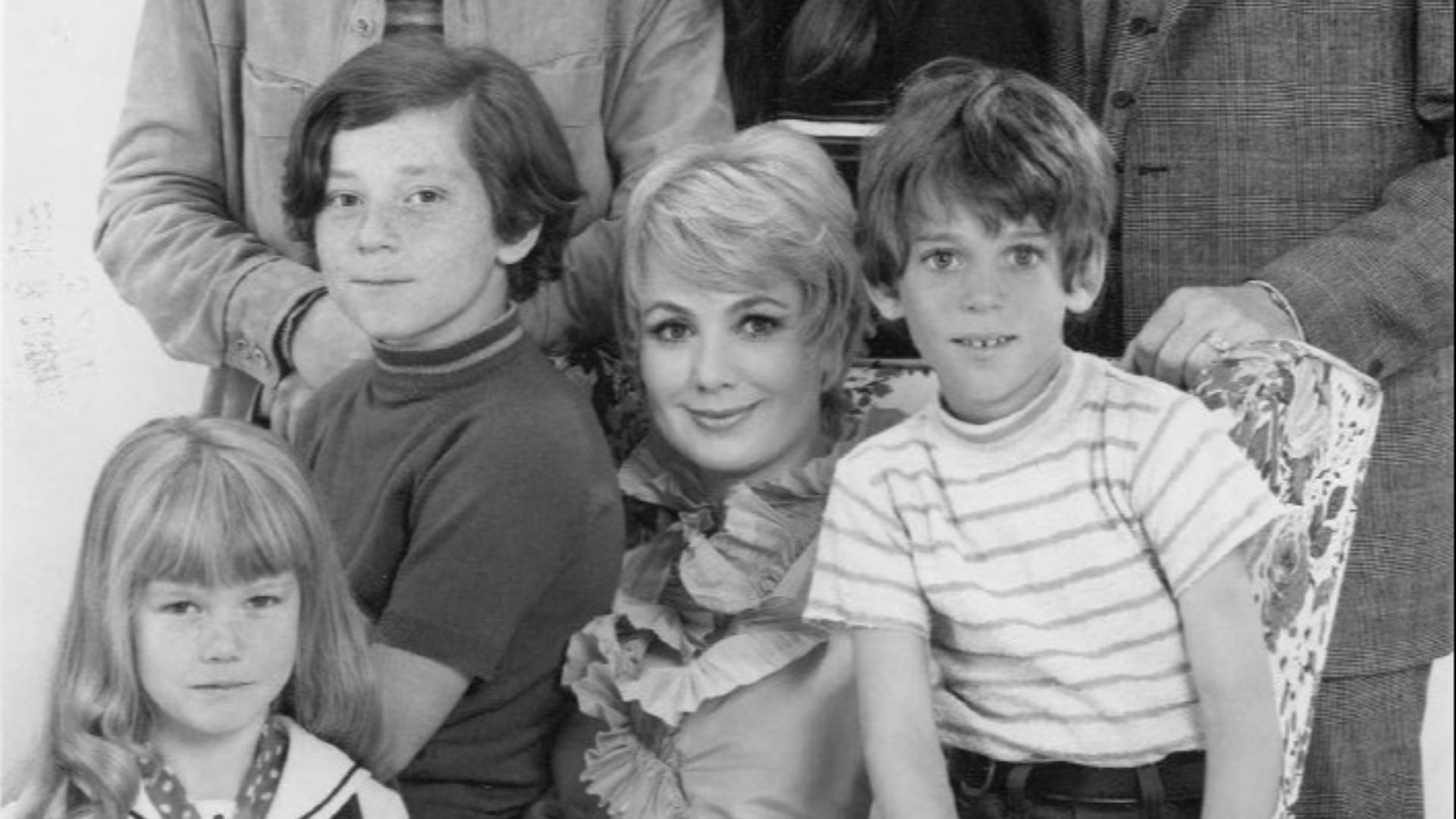 Publicity photo of television actors, (standing; L–R) David Cassidy, Susan Dey, Dave Madden, (sitting; L–R) Danny Bonaduce, Shirley Jones, Jeremy Gelbwaks, and (front; left) Suzanne Crough  promoting the ABC comedy series The Partridge Family, circa 1970.
