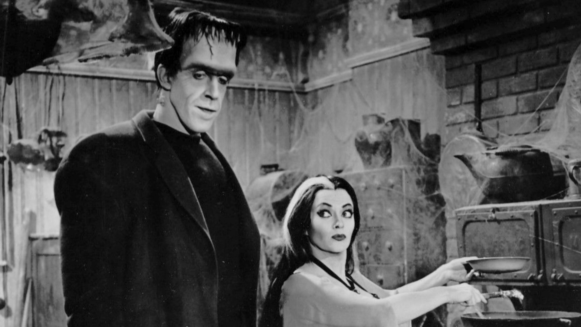 Photo of Fred Gwynne (Herman Munster) and Yvonne DeCarlo as his wife, Lily, from the television program The Munsters.