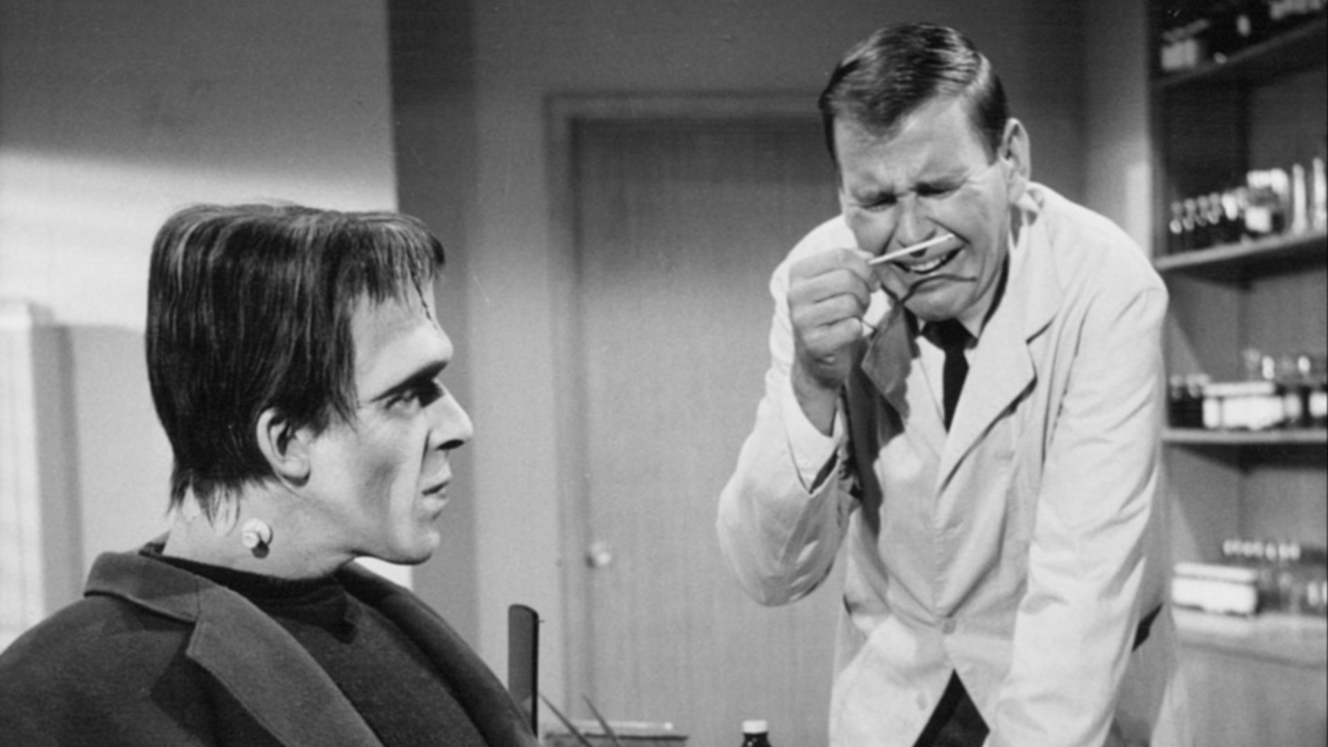 Photo of Fred Gwynne as Herman Munster and Paul Lynde as a doctor he's consulting for weight loss from The Munsters. The episode is