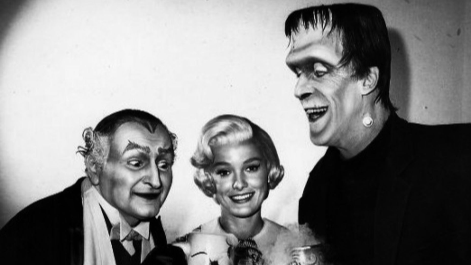 Publicity photo from the television program The Munsters for Halloween.  Pictured from left: Al Lewis (Grandpa), Beverley Owen (Marilyn), and Fred Gwynne (Herman Munster).