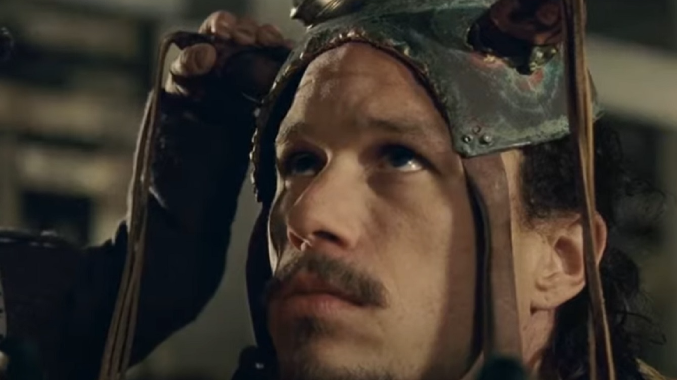 Screenshot: Heath Ledger With long hair wearing grey jacket and helmet looking upset - from The Imaginarium of Doctor Parnassus (2009)