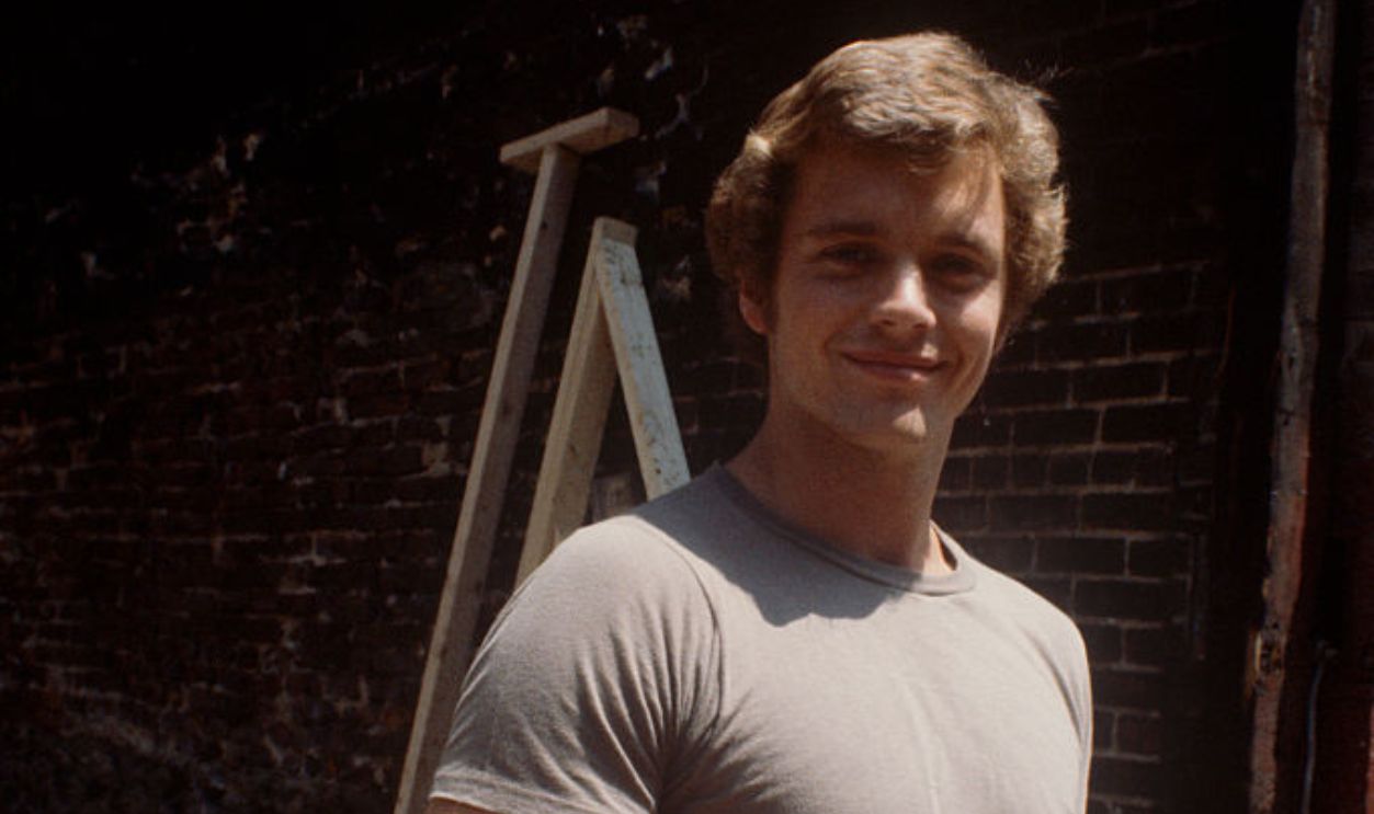 John Schneider in a gray t-shirt and jeans; circa 1970; New York.