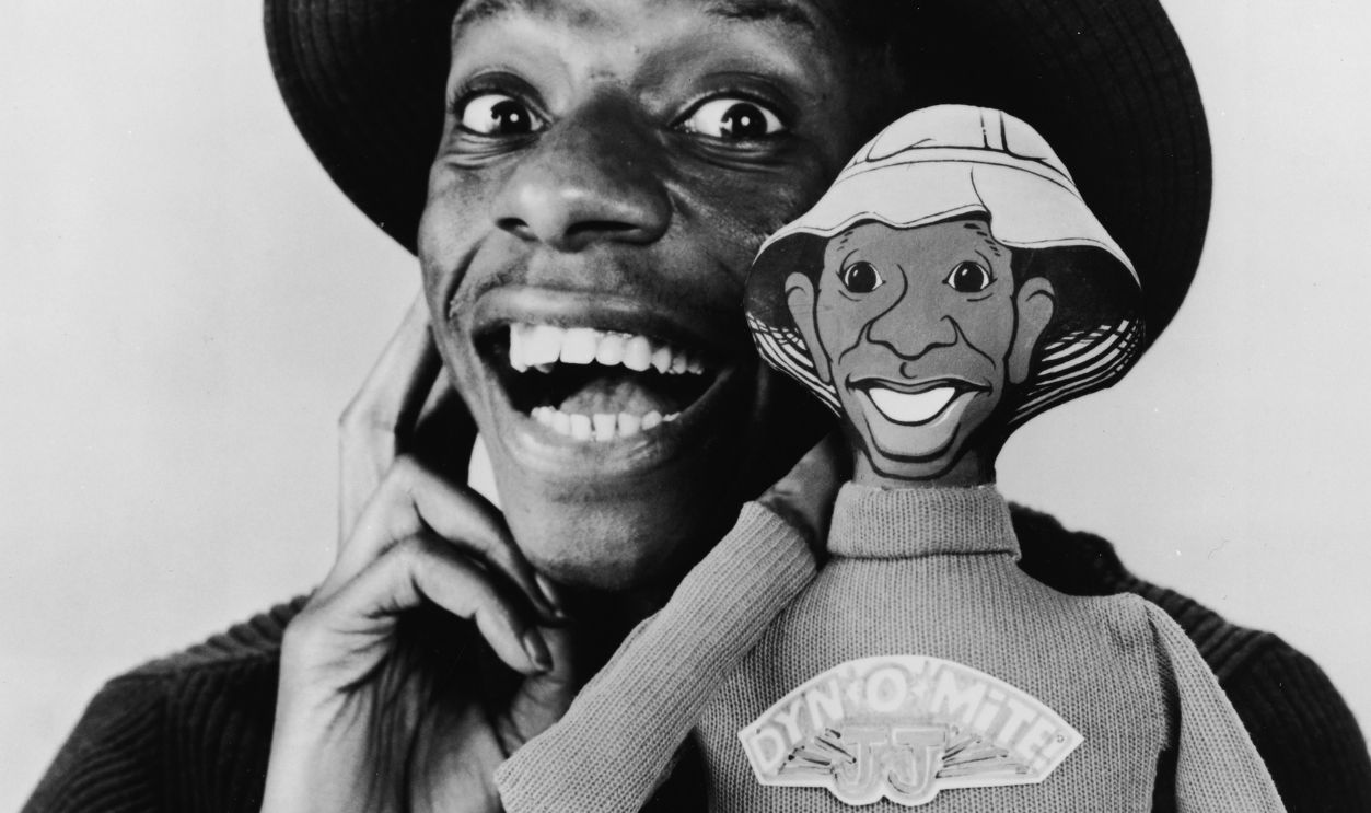 Jimmie Walker As 'J. J.' In 'Good Times' Promotional portrait of American actor Jimmie Walker as he poses with a talking doll based on his character 'J. J.' from the television series 'Good Times,' . The doll features J. J.'s catchphrase, 'Dyn-O-Mite,' on its sweater. 