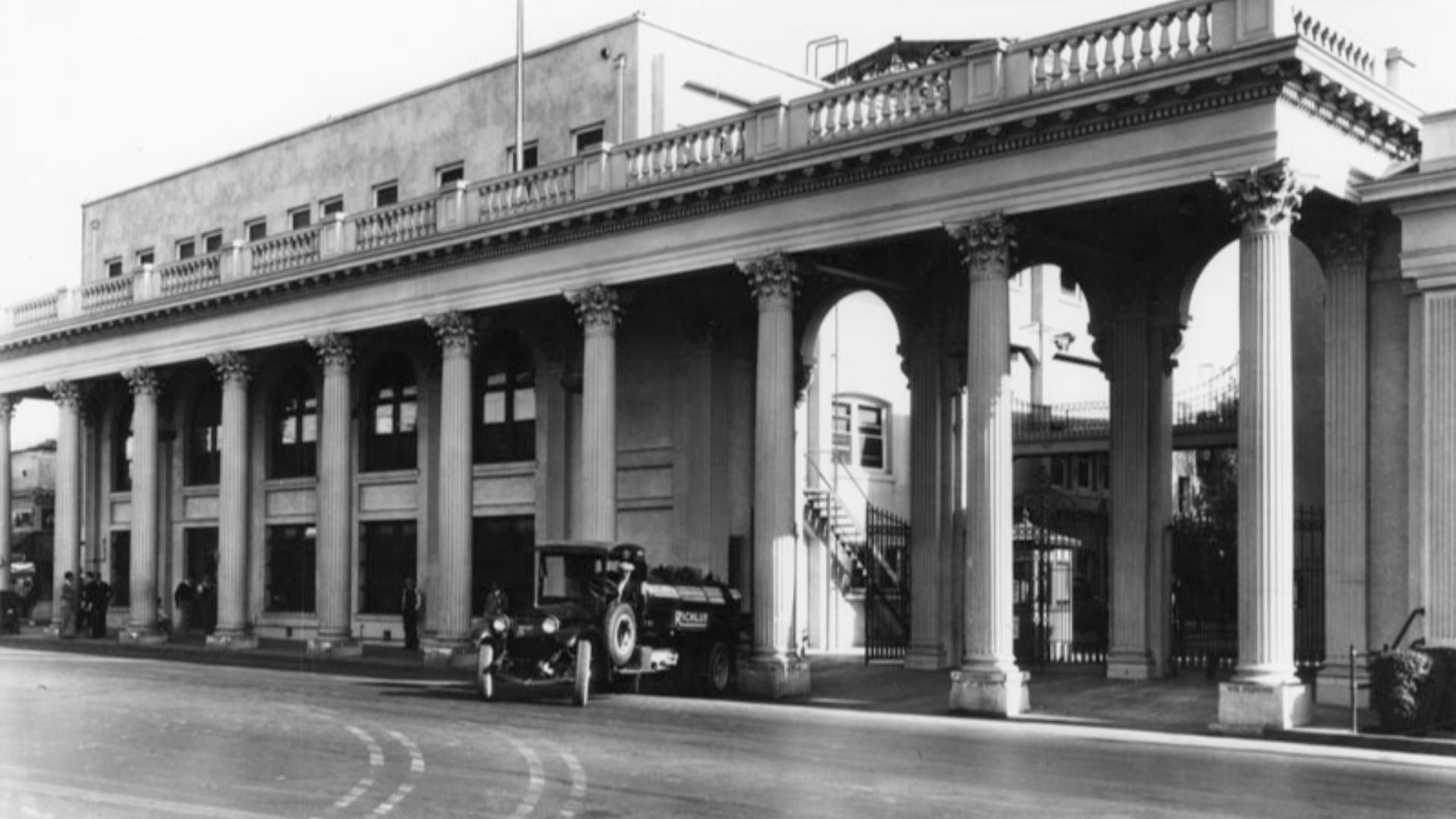 Exterior view of the Triangle at Metro-Goldwyn-Mayer Studios, located at 10202 Washington Boulevard in Culver City. A Richfield gasoline truck is seen in front of the columned building. Photo dated: 1916.