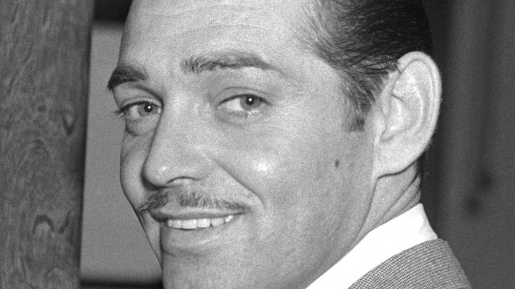 Film actor Clark Gable entering the office of the Assistant U.S. Attorney Jack Powell