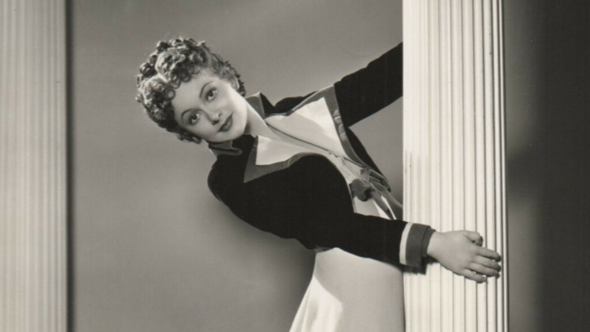 Olivia de Havilland. Publicity photo by Scotty Welbourne. On verso photographer's ink stamp