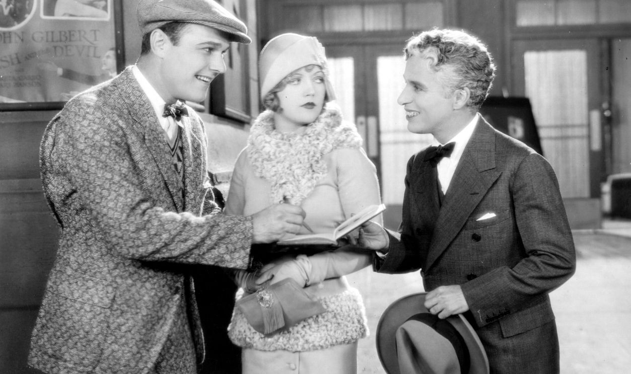  American leading man William Haines (1900 - 1973) stars with Marion Davies (1897 - 1961) and legendary British comedian Charles Chaplin (1889 - 1977) in the film 'Show People', directed by King Vidor for MGM. Chaplin appeared without make-up as himself for the extra's fee of $7.50.