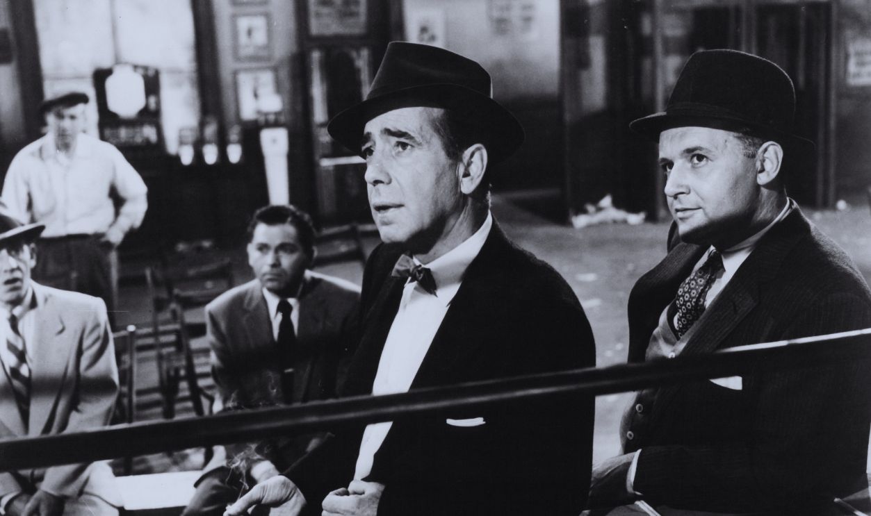 Gettyimages - 129737370, Humphrey Bogart And Rod Steiger In 'The Harder They Fall' Humphrey Bogart and Rod Steiger discuss plans for a phony buildup for a giant heavyweight boxing prospect in a scene from the film 'The Harder They Fall', 1956.