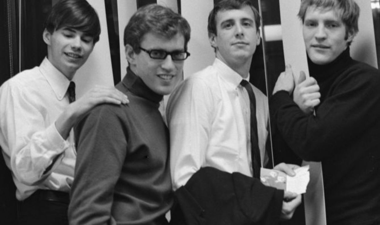 American rock group The Cyrkle (American keyboard player Michael Losekamp, American drummer Marty Fried, American singer and guitarist Don Dannemann, and American singer and guitarist Tom Dawes (1944-2007)), pose with Dawes hugging a pillar, location unspecified, circa 1965. 