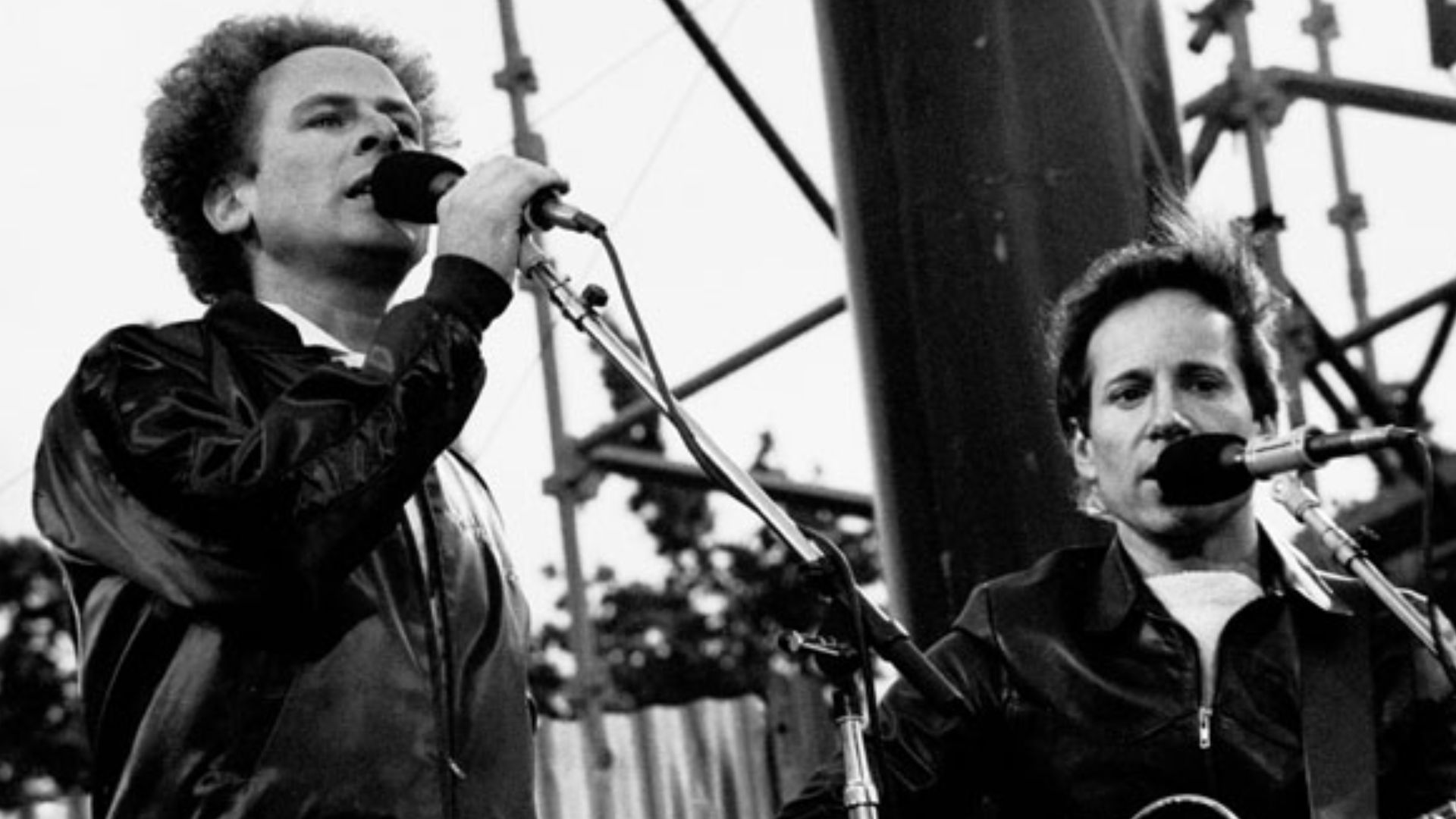 Singer-Songwriter duo Simon & Garfunkel performing outside at a concert in Dublin