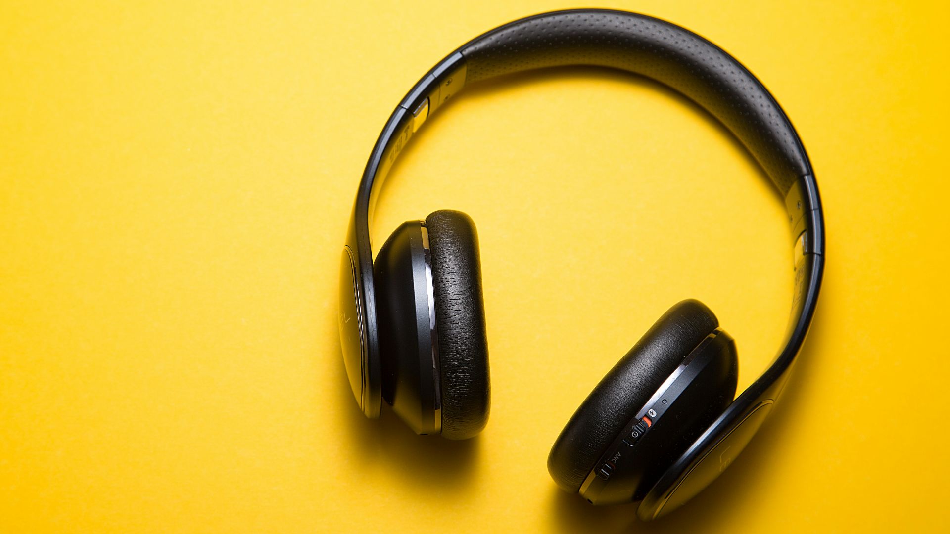 flatlay photography of wireless headphones
