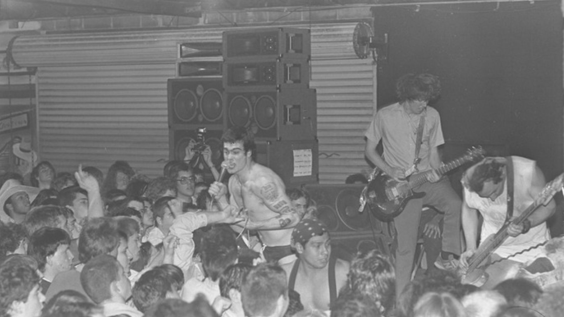 Black Flag performing at Mi Casita in Torrance. Greg Ginn, guitarist and singer-songwriter, and Kira Roessler, bass guitarist, are UCLA alumni. 1983-01-16