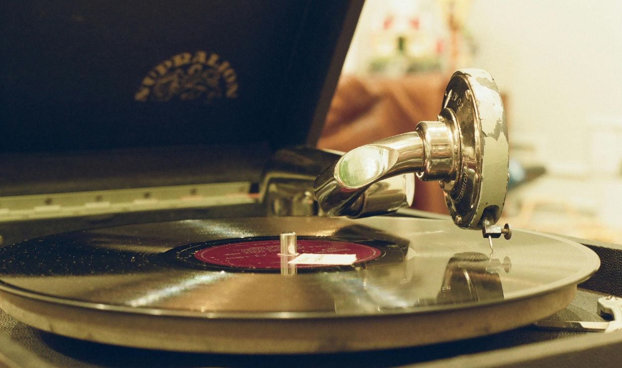 Close-up of a vintage gramophone playing a classic vinyl record indoors.