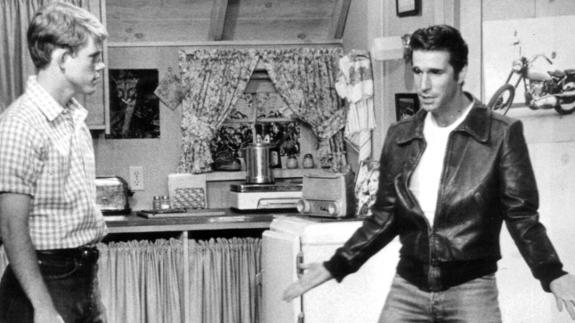 Publicity photo from Happy Days. Pictured are Richie (Ron Howard) and Fonzie (Henry Winkler) at Fonzie's apartment over the Cunningham's garage. The episode deals with Fonzie's destroyed motorcycle.