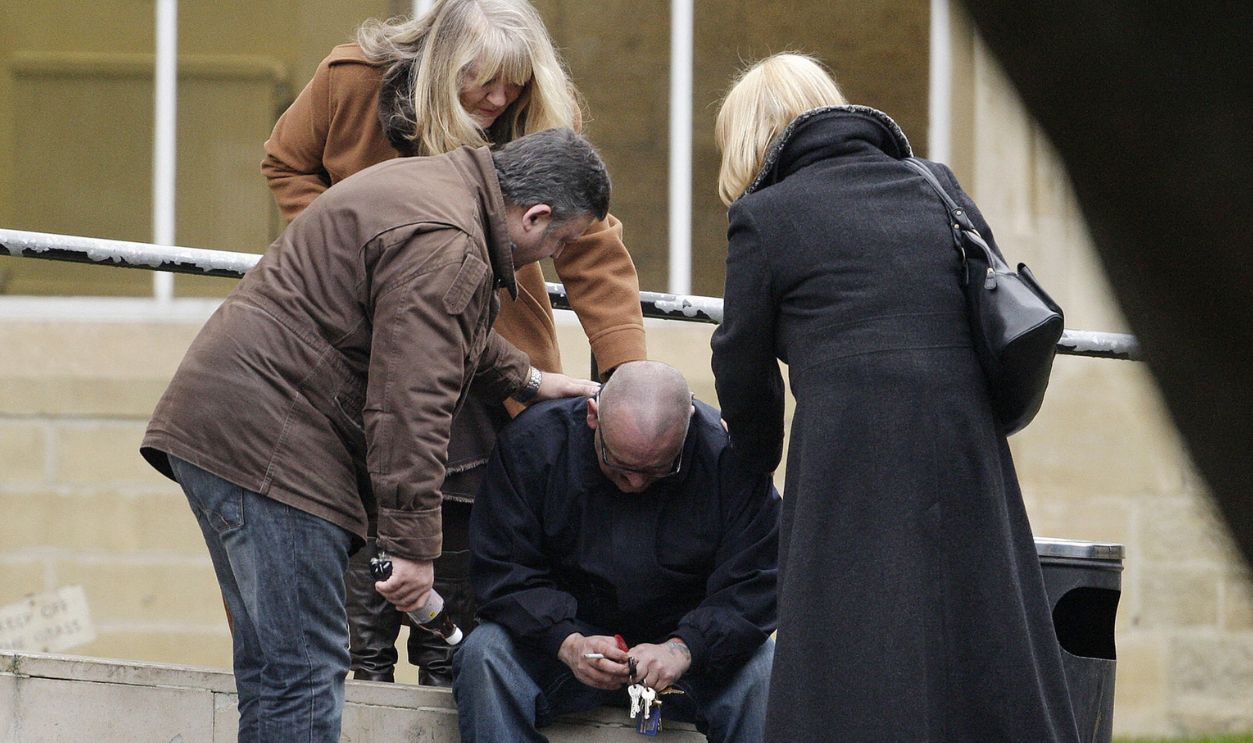 Kevin O'Dowd, (C) a brother of British musician Boy George, is comforted outside Snaresbrook Crown Court, east of London, on January 16, 2009, after his brother receives a prison sentence of 15 months.
