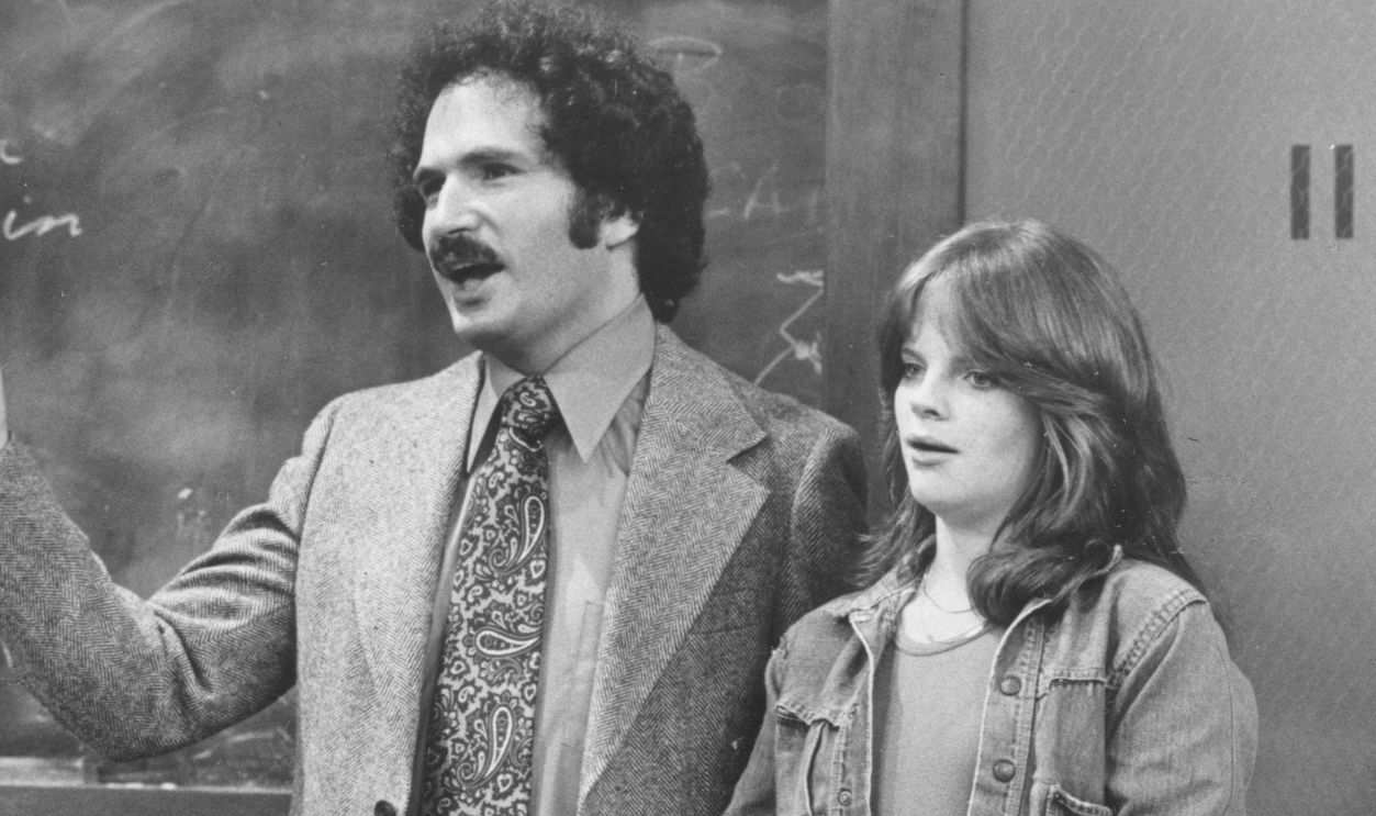 Gabe Kaplan & Debralee Scott Gabe Kaplan and Debralee Scott standing in front of a classroom on the television sitcom Welcome Back Kotter, August 10, 1976.