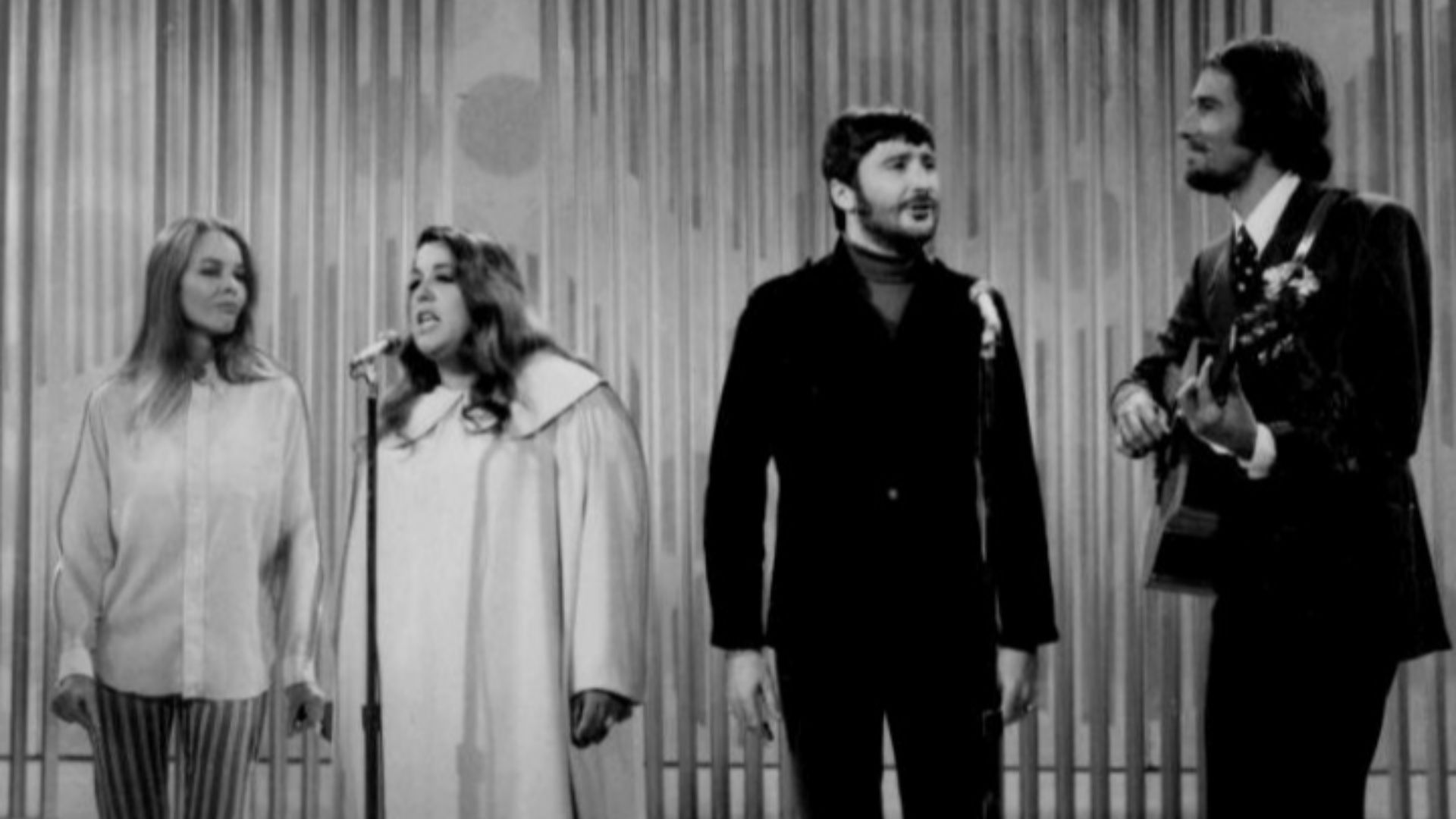 Photo of The Mamas and the Papas performing on The Ed Sullivan Show. From left-Michelle Phillips, Cass Elliot, Denny Doherty, and John Phillips.