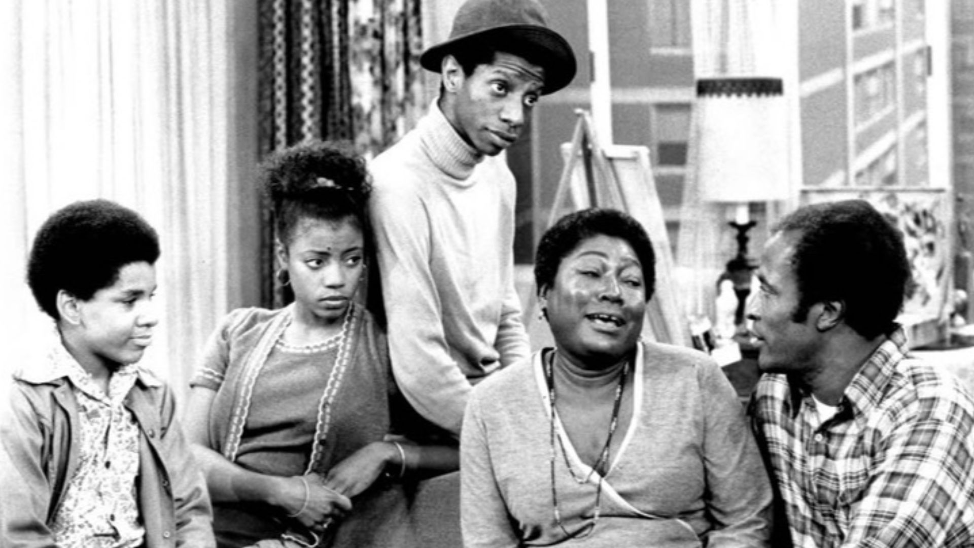 Photo of the Evans family from the television program Good Times.  From left: Ralph Carter (Michael), BernNadette Stanis (Thelma), Jimmie Walker (J.J.), Esther Rolle (Florida), John Amos (James).
