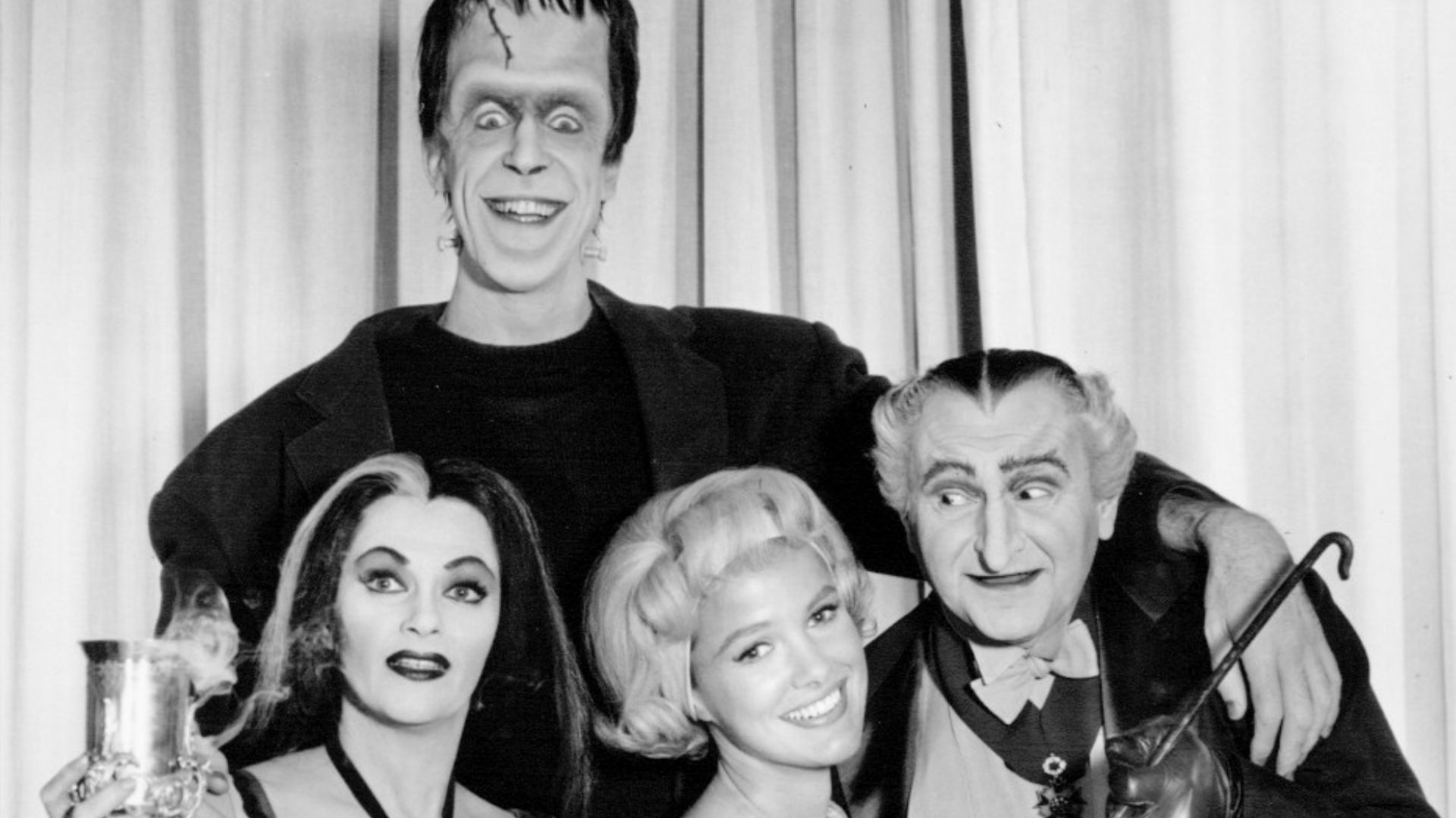 Cast photo of the Munsters.  The only cast member not pictured is Butch Patrick as Eddie.  From left-Yvonne De Carlo (Lily), Fred Gwinne (Herman), Bevereley Owen (Marilyn) and Al Lewis. (Grandpa).