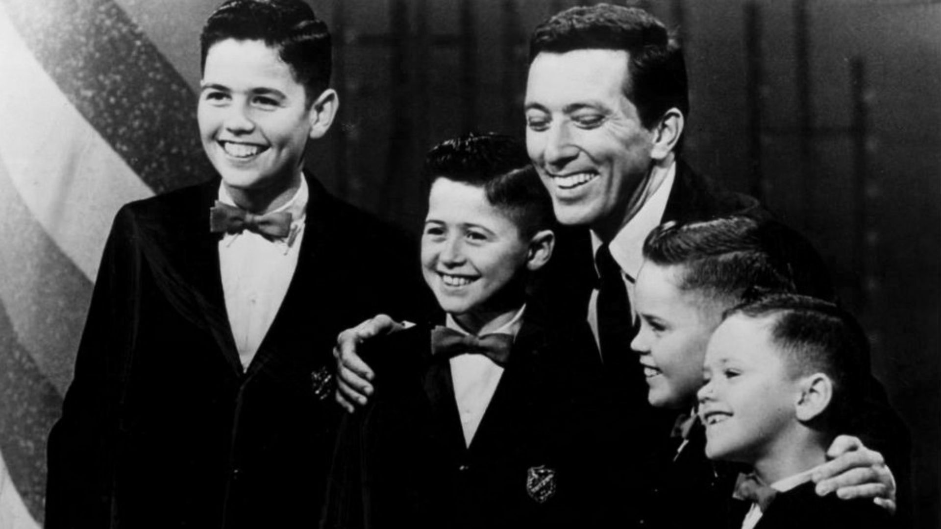 Publicity photo of the young Osmond Brothers with singer Andy Williams. The young boys were regulars on Williams' television show from 1962 to 1969. From left: Alan, Wayne, Andy Williams, Merrill, and Jay.