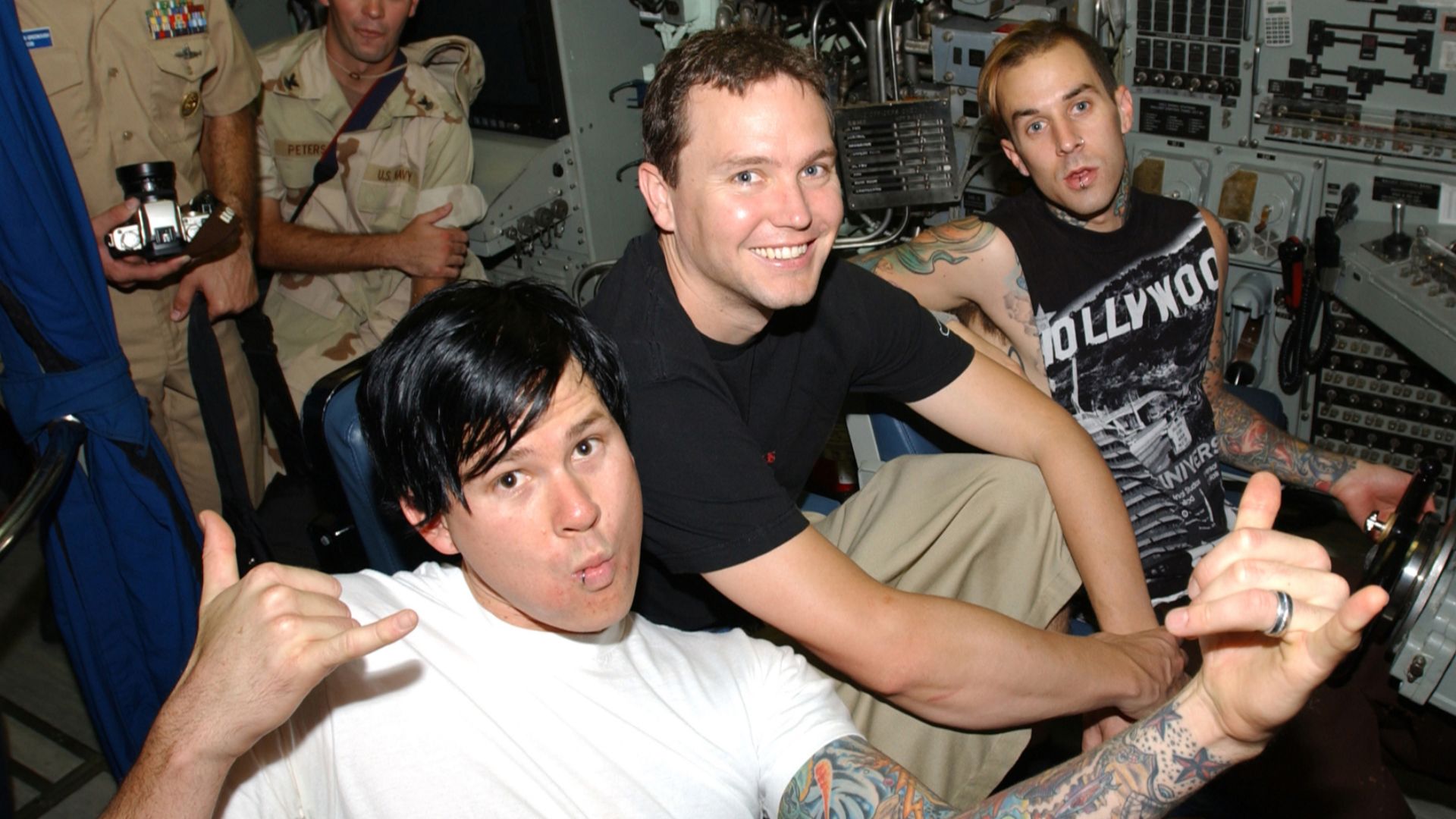 Members of the rock band Blink-182 sit at the ship’s controls pier-side aboard the nuclear-powered attack submarine USS Memphis (SSN 691). Morale Welfare and Recreation, Naval Personnel Command Millington, Tenn. and MWR, NSA Bahrain brought Blink-182 to B