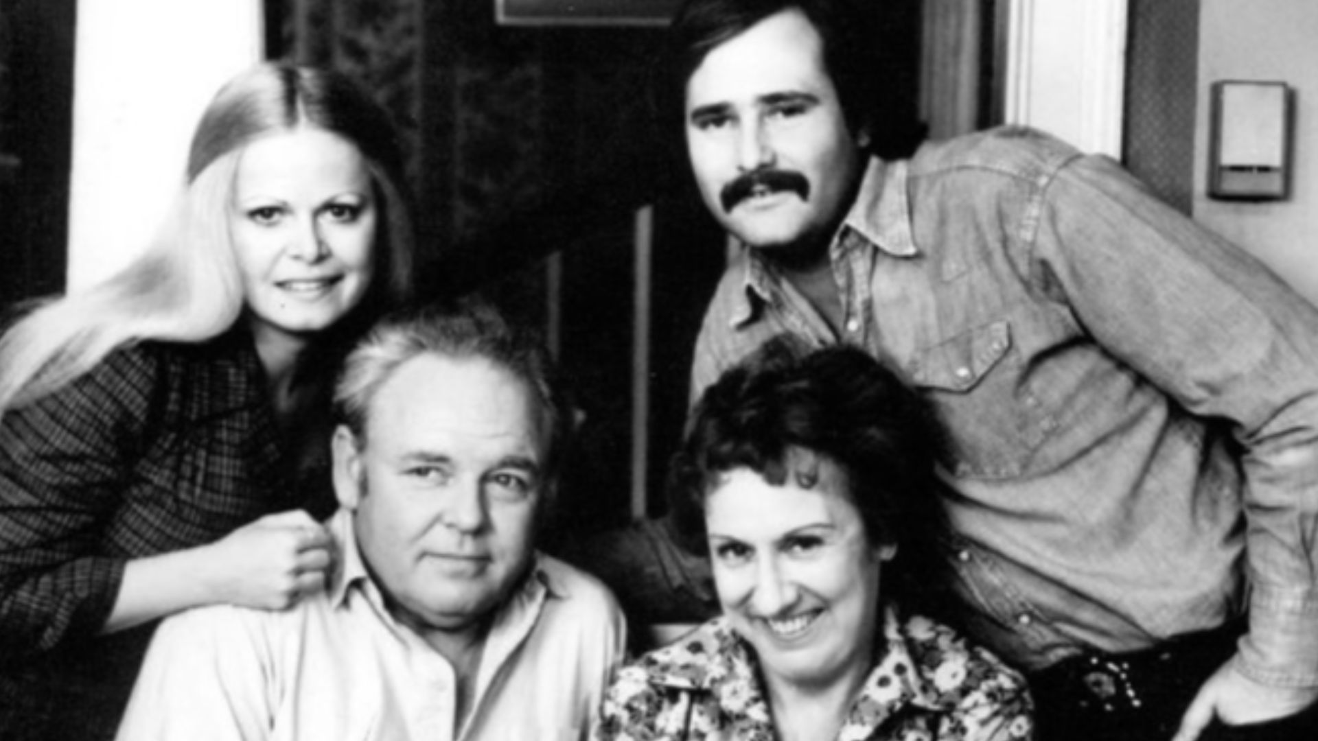 Photo of the Cast of the television program All in the Family.  Standing are Sally Struthers (Gloria) and Rob Reiner (Michael); seated are Archie (Carroll O'Connor) and Edith (Jean Stapleton), who is holding the child who played the Bunker's grandson, Joe