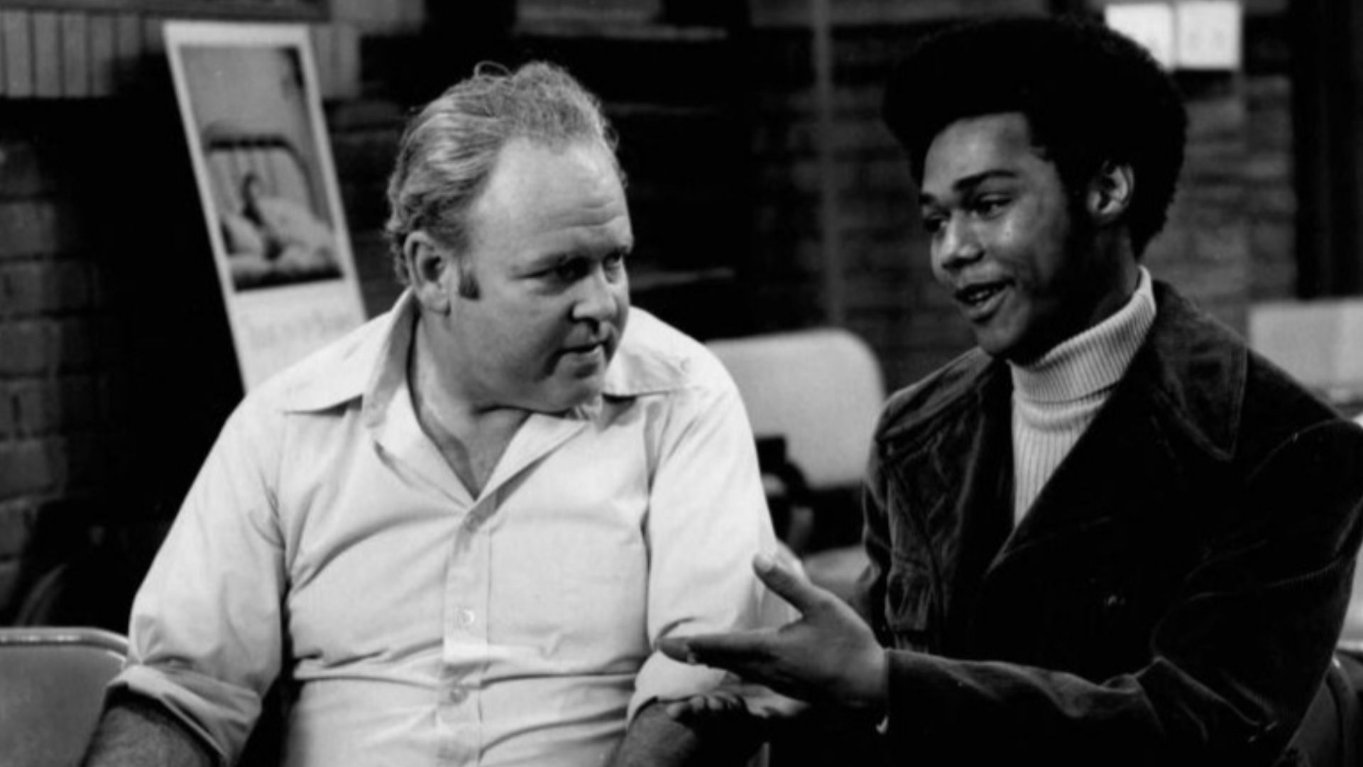 Publicity photo from the television program All in the Family.  Pictured are Carroll O'Connor (Archie Bunker) and Michael Evans (Lionel Jefferson).  In this episode, Archie visits a local blood bank to donate and meets his neighbor, Lionel Jefferson, who 