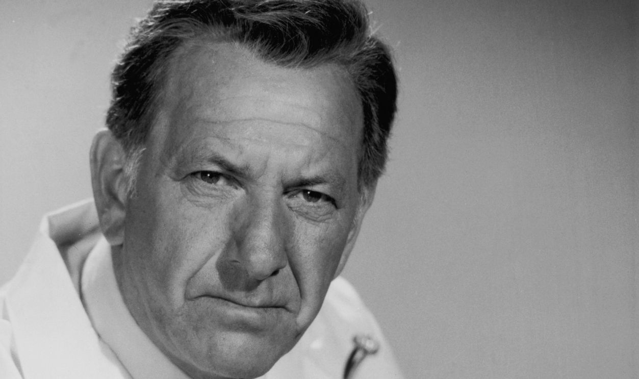 Getty Images - 3206564 - American actor Jack Klugman holds a bullet in a pair of tweezers and an x-ray in a promotional portrait for the television series 'Quincy'. He wears a laboratory coat.