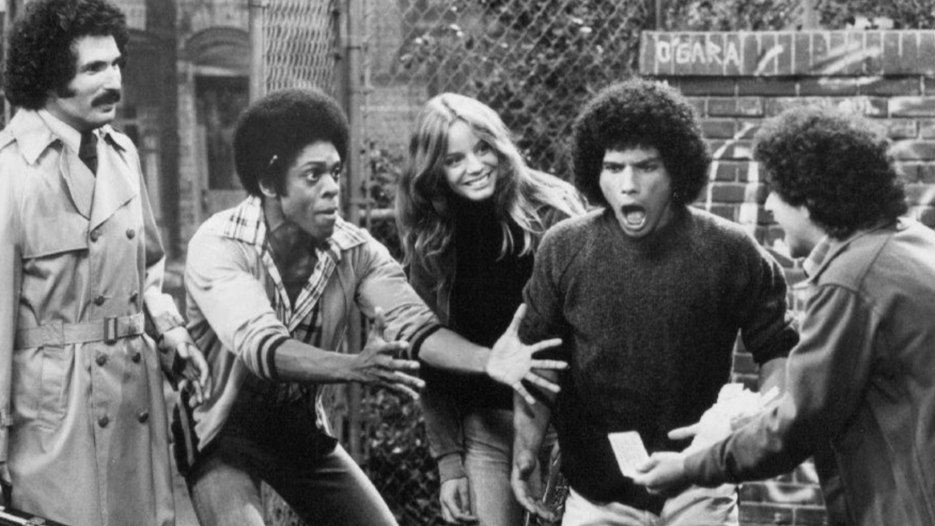 Publicity photo from the television program Welcome Back, Kotter. From left: Gabe Kaplan, Lawrence Hilton-Jacobs, Wendy Rastatter, Robert Hegyes, and Ron Palillo.  The Sweathogs are celebrating a winning New York State lottery ticket while Mr. Kotter look