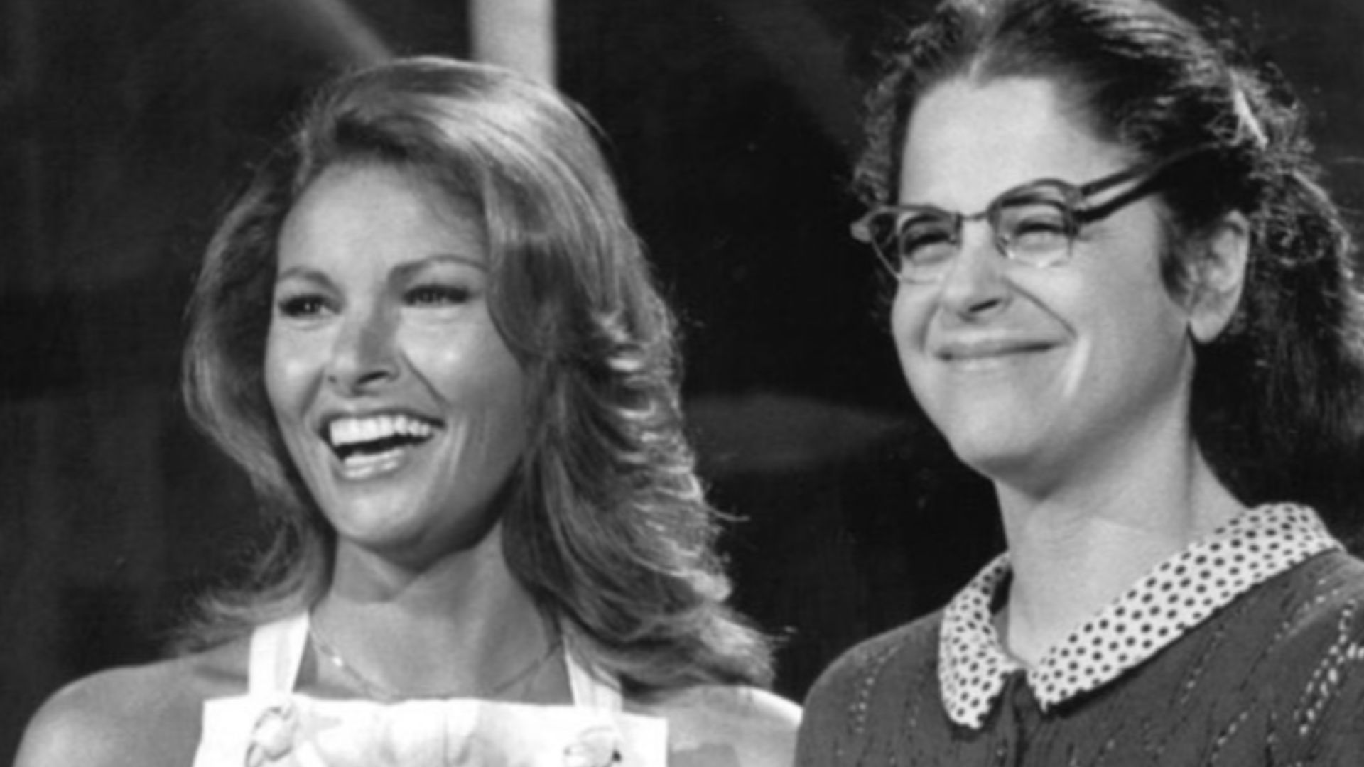 Publicity photo of Raquel Welch and Gilda Radner from Saturday Night Live rehearsal, April 24, 1976. Radner is shown as dressed as Emily Litella.